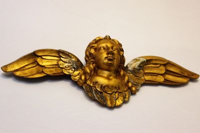 Close-up of angel statue against white background