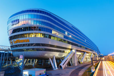 Low angle view of modern building against blue sky