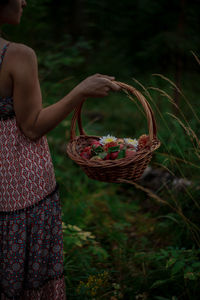 Midsection of woman holding ice cream in basket