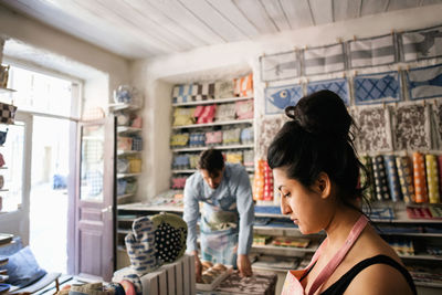 Man and woman working in fabric shop