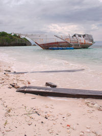 Boat on beach against sky