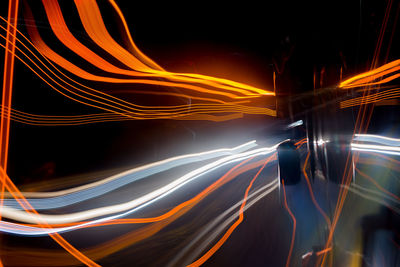 Digital composite image of light trails on road at night