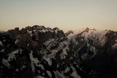 Scenic view of snowcapped mountains against clear sky