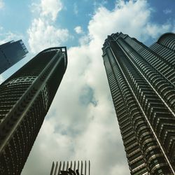 Low angle view of buildings against cloudy sky