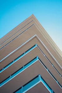 Low angle view of modern building against clear blue sky