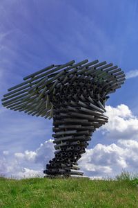 Low angle view of built structure on field against sky