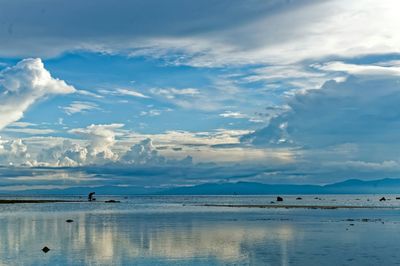 Scenic view of mountains against cloudy sky