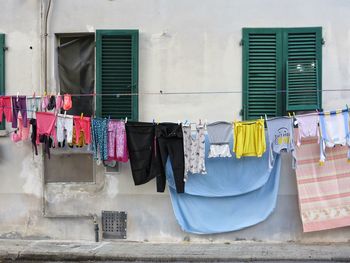 Clothes drying on clothesline outside building