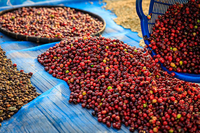 Raw coffee beans dry on shelf in the nature