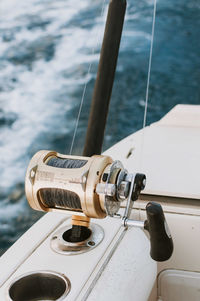 High angle view of fishing pole on boat in sea