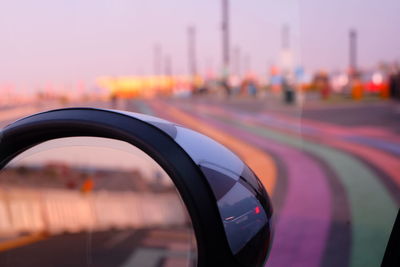 Close-up of multi colored light against sky during sunset