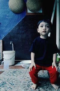 Portrait of cute boy sitting at home