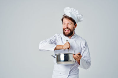 Young man wearing mask against white background