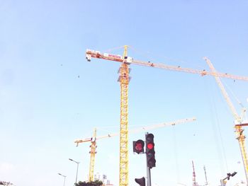Low angle view of construction site against clear blue sky