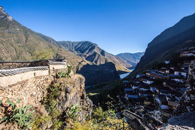 Scenic view of mountains against clear blue sky