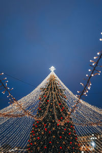 Festive sparkling golden garlands and  decorations with christmas tree as symbol of happy new year