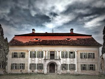 Low angle view of building against cloudy sky