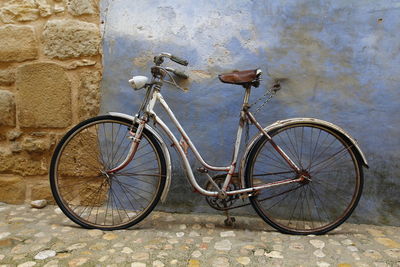 Bicycle parked on wall