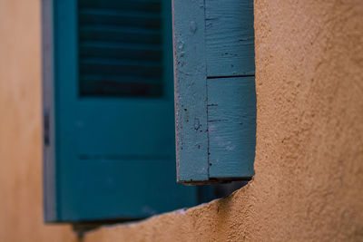 Close-up of blue window on wall of building