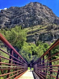 Narrow footbridge leading towards mountain