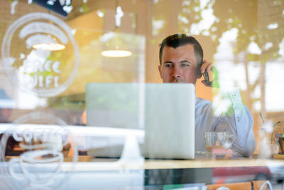 Portrait of man working on table