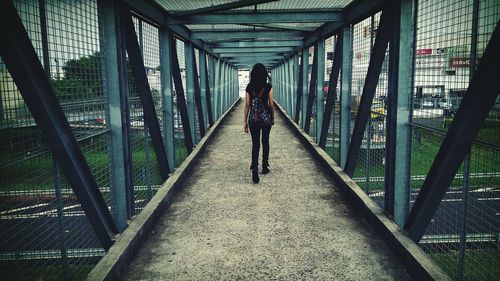 Full length of woman standing on bridge