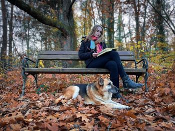 Side view of woman sitting in park