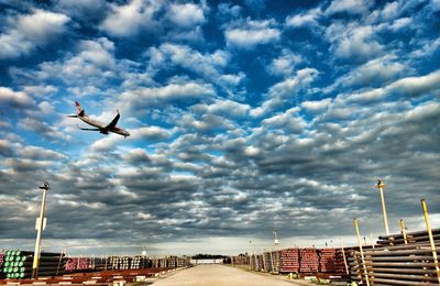Low angle view of airplane against clouds