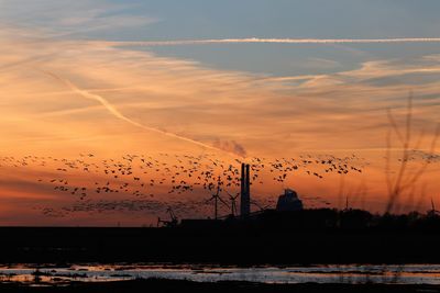 Scenic view of silhouette land against sky during sunset