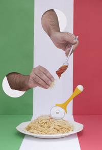 Midsection of person holding ice cream on table