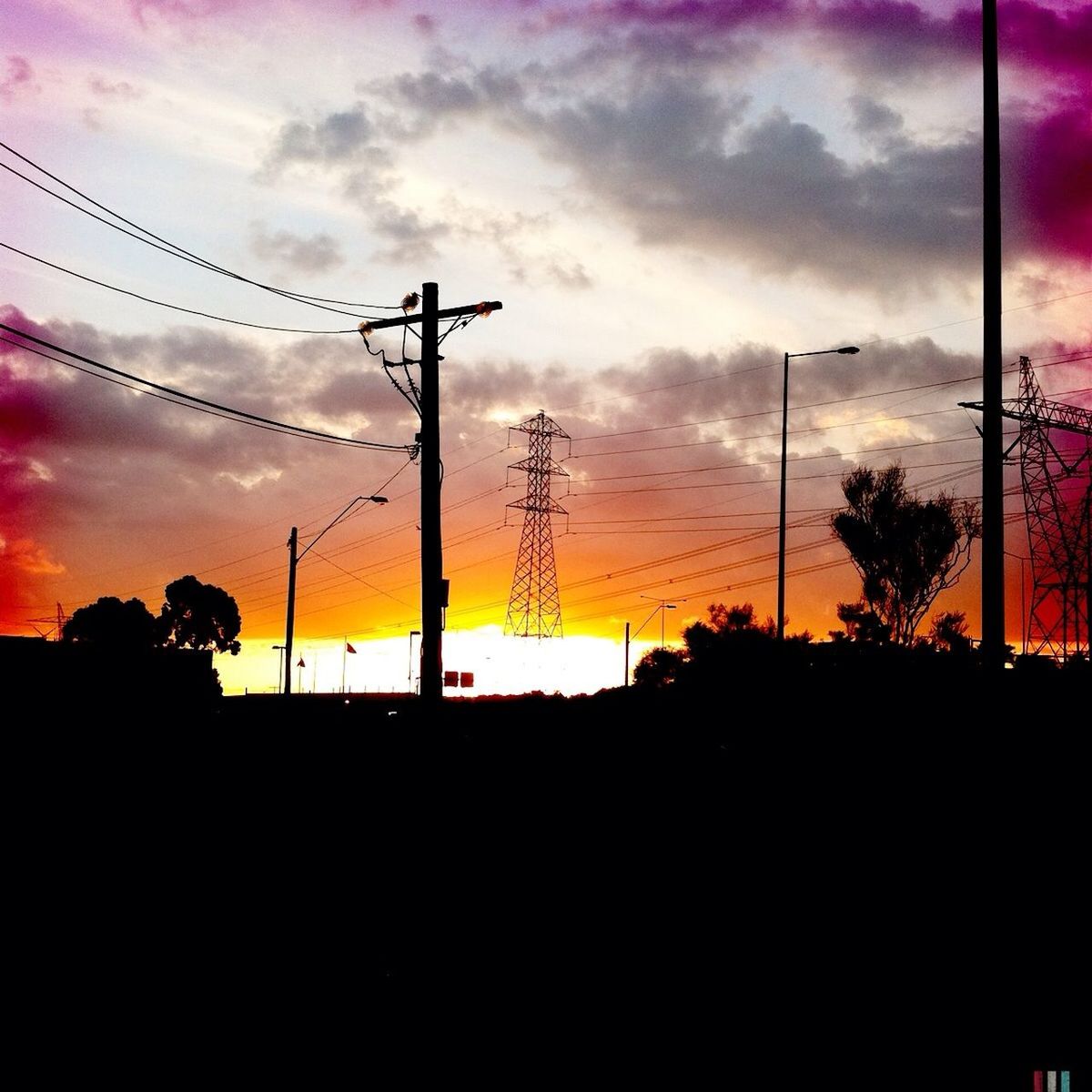 sunset, silhouette, sky, scenics, electricity pylon, power line, beauty in nature, tranquil scene, tranquility, orange color, cloud - sky, tree, nature, idyllic, cloud, dark, landscape, dusk, dramatic sky, electricity