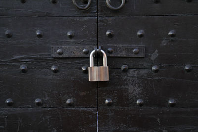 Close-up of padlock on closed door