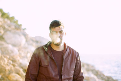 Portrait of young man smoking