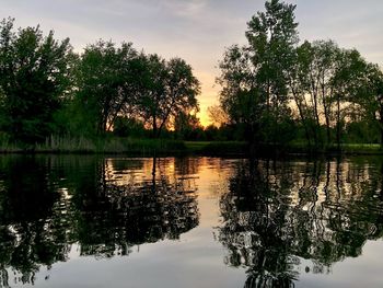 Scenic view of lake against sky at sunset