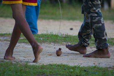 Low section of boys spinning top at playground