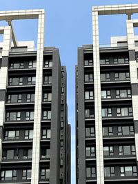 Low angle view of buildings against blue sky