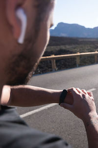 Close-up of man holding hands on street