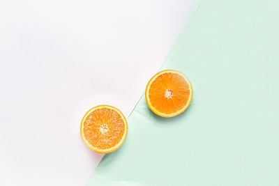 High angle view of orange fruit against white background