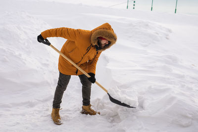 Low section of man skiing on snow