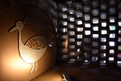 Close-up of illuminated lamp on table