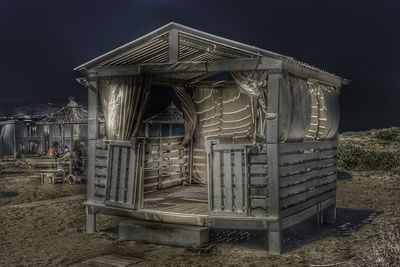 Built structure on field against sky