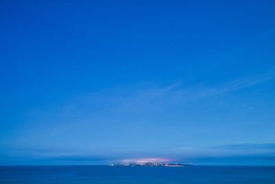 Scenic view of sea against blue sky