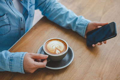 High angle view of coffee cup on table