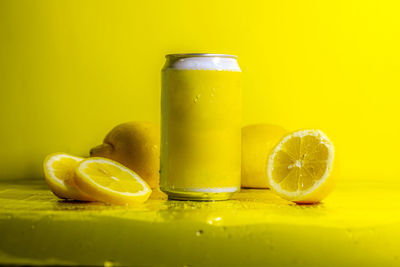 Close-up of drink on table against yellow background