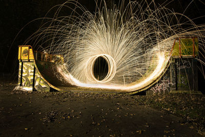 Burning wire wool on skateboard ramp at night