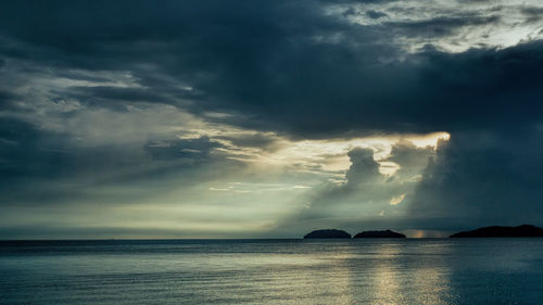 Scenic view of sea against storm clouds