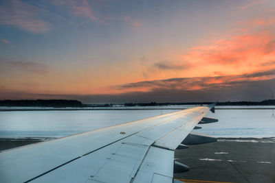 View from inside an airplane taxiing before a winter evening departure