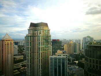 Skyscrapers against cloudy sky