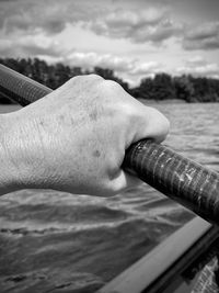 Cropped hand of man holding water