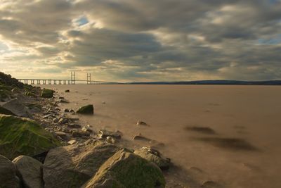 View of beach against cloudy sky